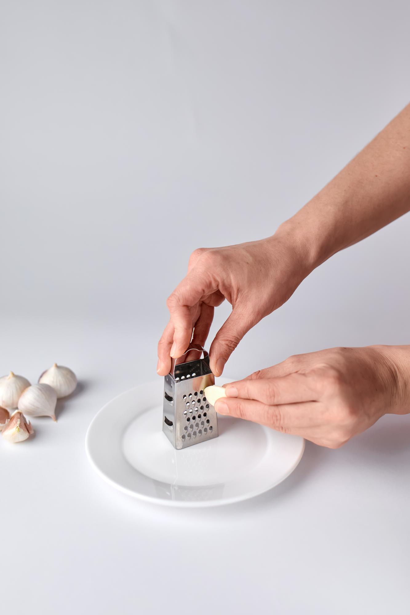 Hands arranging garnish on small plates